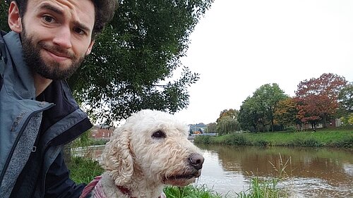 Will Aczel with dog Ayla by the River Exe, near Exeter Quay 